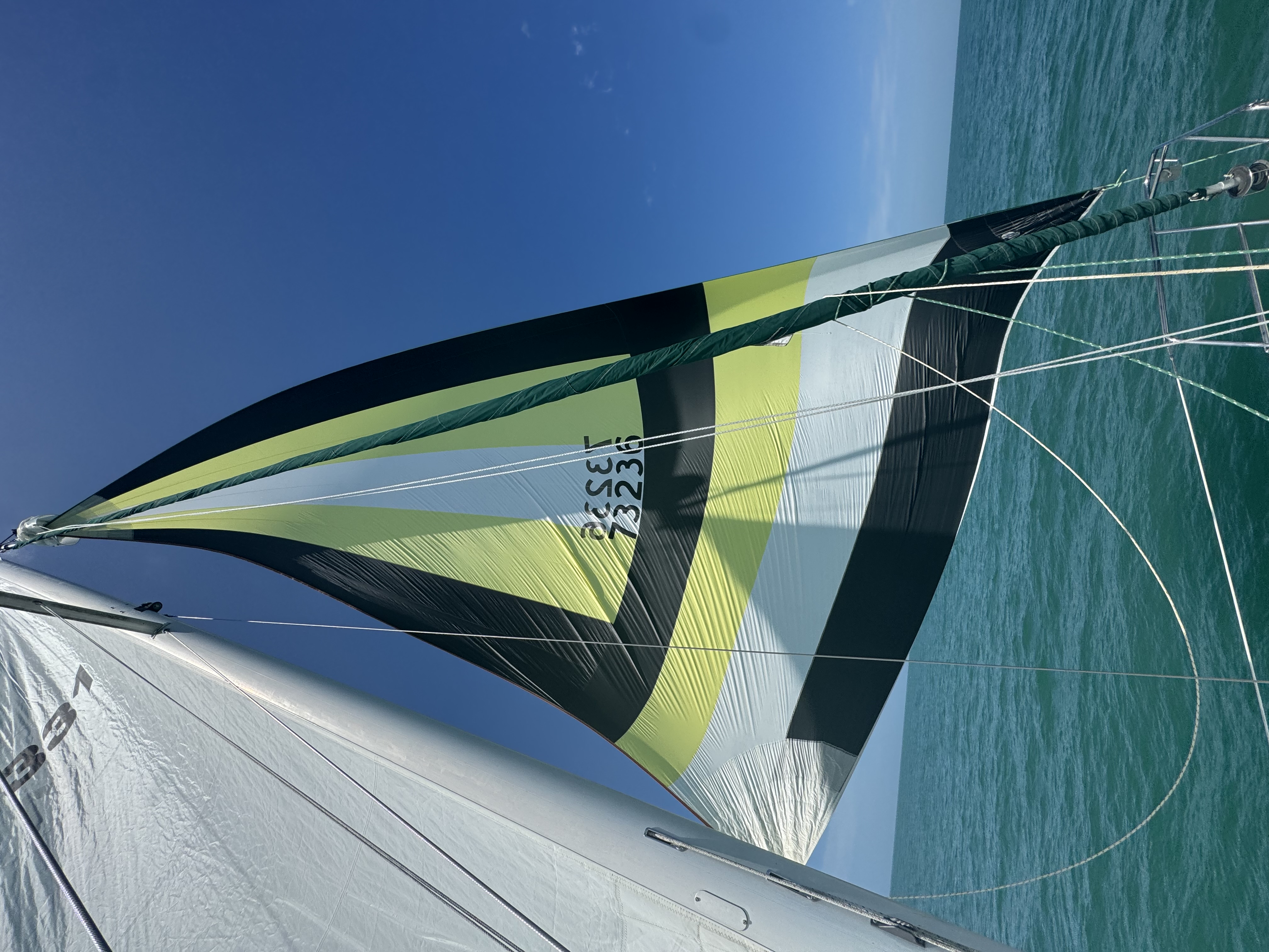 Northern Lights sailing with colorful asymmetrical spinnaker deployed